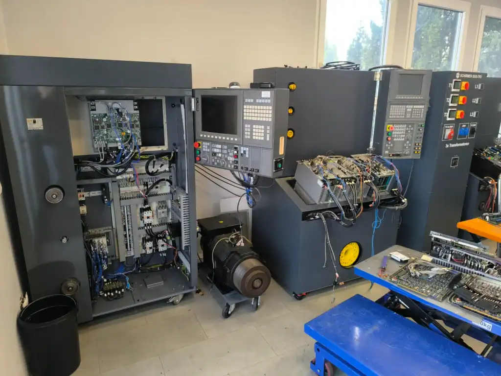 Open Okuma CNC machine showing internal drive electronics