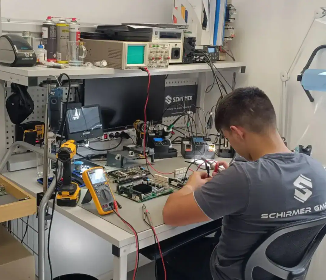 Schirmer GmbH technician working on CNC electronics