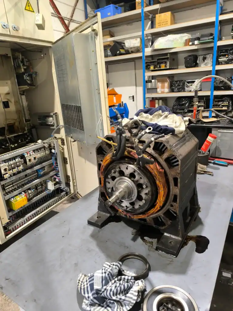 Okuma servo motor disassembled for repair and inspection in workshop