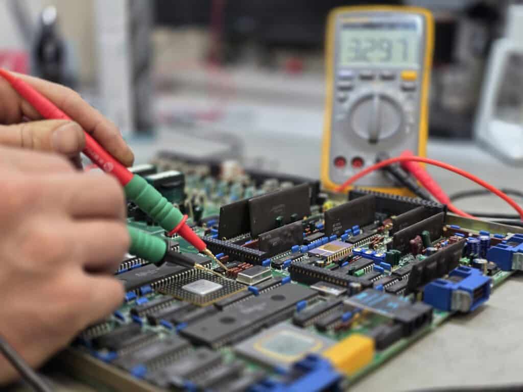 Electronics technician soldering a control board